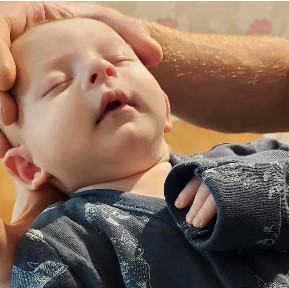 Baby receiving Craniosacral Therapy